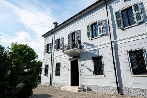 a white building with a door and a balcony at Le Dolci Dimore in Virgilio