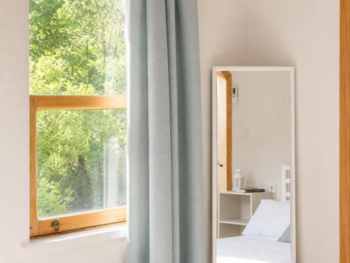 a bedroom with a window and a mirror at Sea Salt Inn in Kemer