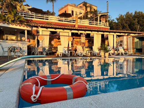 a swimming pool with a red raft in the water at B&B Sole e Luna in Palermo