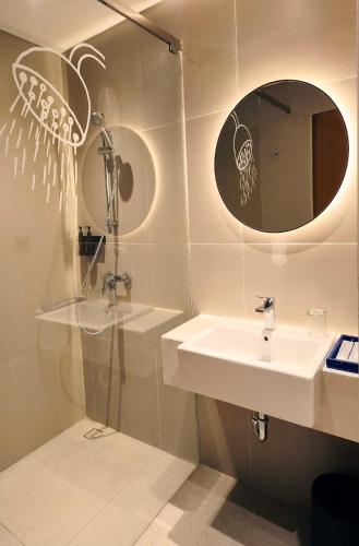 a bathroom with a sink and a shower at Samai Suites in Bandar Lampung