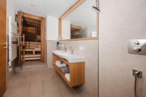 a bathroom with a sink and a shower at Appartementhaus Anna in Leogang
