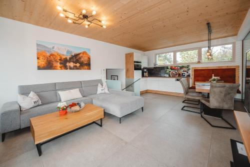 a living room with a couch and a table at Appartementhaus Anna in Leogang