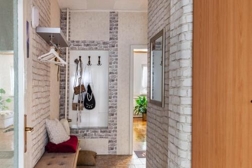 a living room with a brick wall at Ferienwohnung Waldglück in Lauchhammer