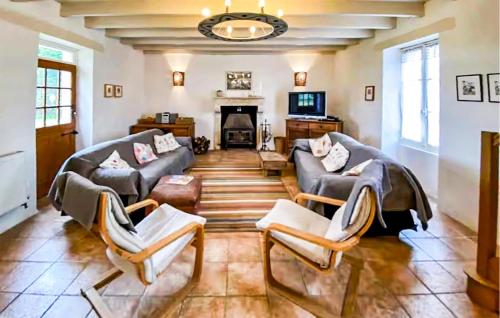 a living room with two couches and a fireplace at Cottage À La Campagne in Mérigny