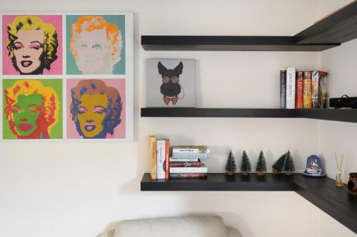 a living room with bookshelves and posters on the wall at Algirdo Apartments, Self Check-in, Free Private Parking in Vilnius