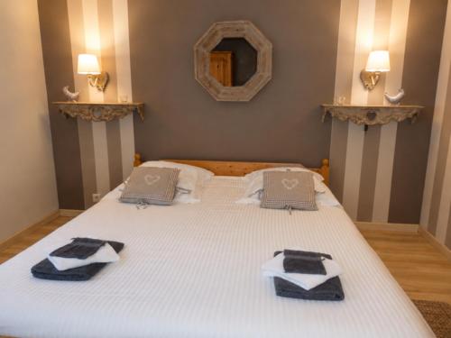 a large white bed with two pillows on it at Chalet de Cligneval in Malmedy