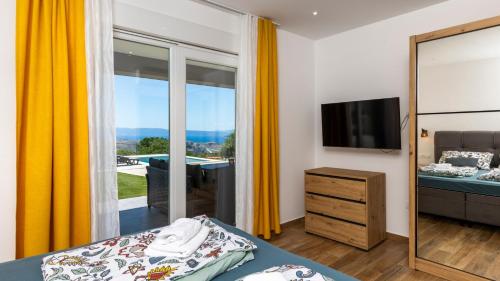 a bedroom with a bed and a mirror at Villa Luminosa by Villas Guide in Kraljevica