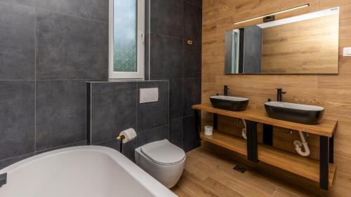 a bathroom with a tub and a sink and a toilet at Villa Luminosa by Villas Guide in Kraljevica