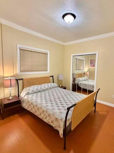 a bedroom with a large bed and a mirror at 3BR Spacious Living Space 1 Parking Private Entry in Richmond