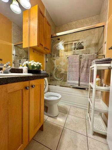 a bathroom with a toilet and a sink at 3BR Spacious Living Space 1 Parking Private Entry in Richmond