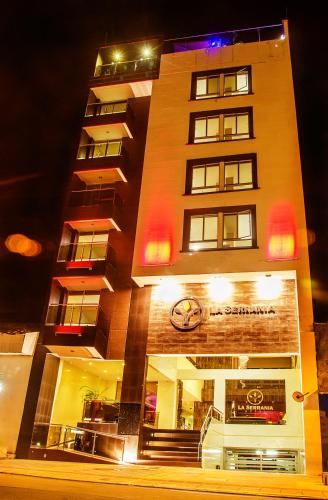a tall building with a clock on it at night at Hotel La Serrania Bucaramanga in Bucaramanga