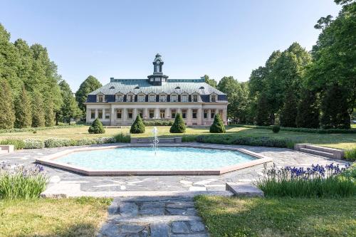a large house with a fountain in front of it at Ahlström Ruukki Noormarkku in Pori