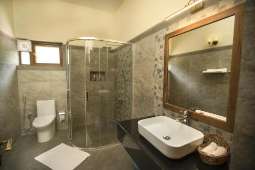 a bathroom with a shower and a sink and a toilet at Sinna Dorai's Moulmein House in Vālpārai