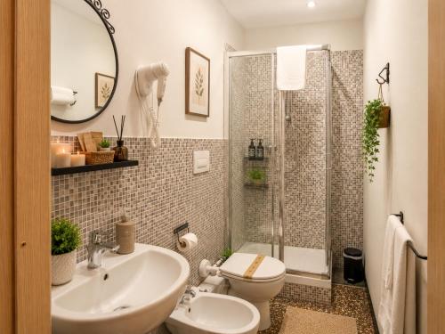 a bathroom with a sink and a toilet and a shower at Villa Catelli in Lucca