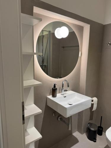 a bathroom with a sink and a mirror at Westerntor City Studio in Paderborn