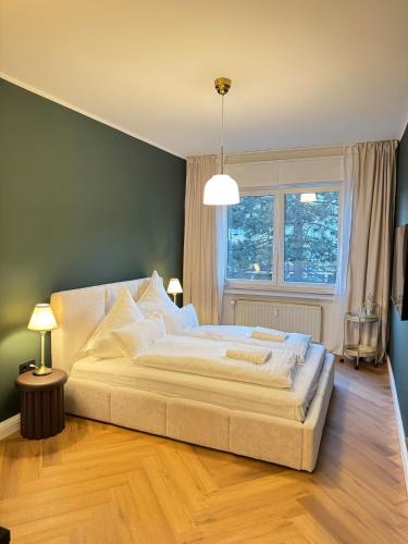a bedroom with a large white bed with a window at Westerntor City Studio in Paderborn