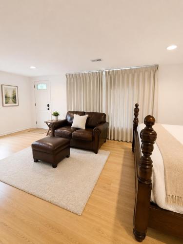 a living room with a bed and a couch at Parkside luxury suite and EV station in Jenkintown