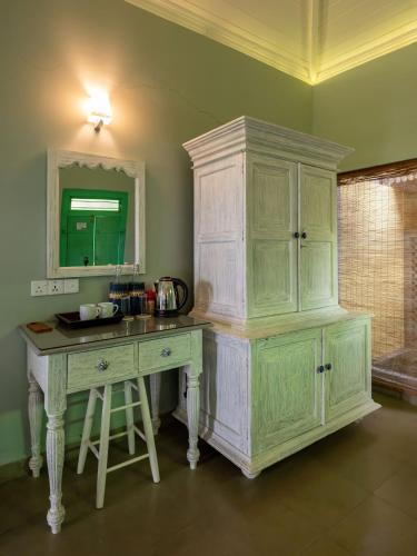 a kitchen with a desk and a large cabinet at Villa Sethawadi Hotel and Kitesurf Centre in Kalpitiya