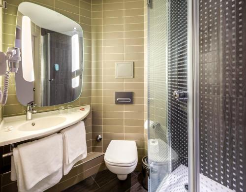 a bathroom with a toilet and a sink and a shower at Ibis Istanbul Tuzla Hotel in Tuzla