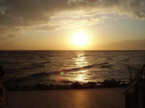 a sunset over the ocean with the sun setting at Hotel Marea in Grado