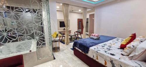a bedroom with a king sized bed and a living room at Hotel Anmol&Rooms in Gothaj