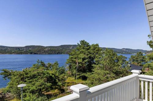 a balcony with a view of a lake at Beach House With Multiple Terraces In Holmsbu in Holmsbu