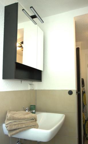 a bathroom with a white sink and a mirror at Rose in Überlingen