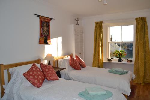 a bedroom with two beds and a window at St Louan's in Alyth