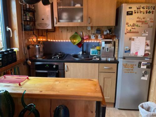 a kitchen with a refrigerator and a table in it at Sleeps 2 includes breakfast in Garve