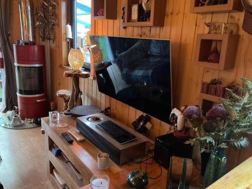 a room with a desk with a computer and a television at Sleeps 2 includes breakfast in Garve