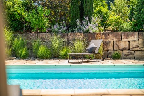 a chair sitting next to a swimming pool at Weingut Landerer in Vogtsburg