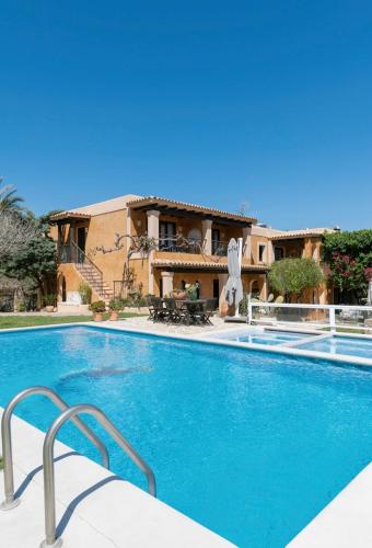 a large swimming pool in front of a house at Casa Naya Ibiza in Sant Llorenç de Balafia