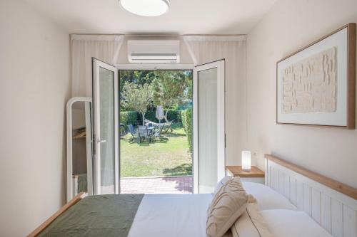 a bedroom with a bed and a sliding glass door at Villa Noa in Cala en Bosc