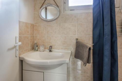 a bathroom with a sink and a mirror at Chambre d'hotes 3 et 4 a la ferme in Champsac