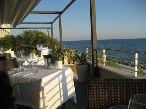 a restaurant with a table with a view of the ocean at Hotel Marea in Grado