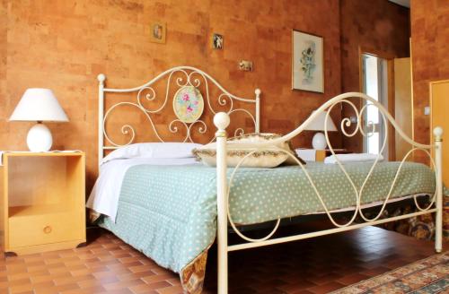 a bedroom with a bed with a white bed frame at Al Villino del Sole in Fano