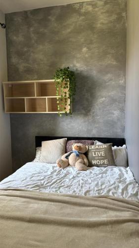 a bed with two teddy bears sitting on it at Butas Karklėje in Karklė