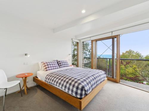 a bedroom with a bed and a large window at Wye View in Wye River