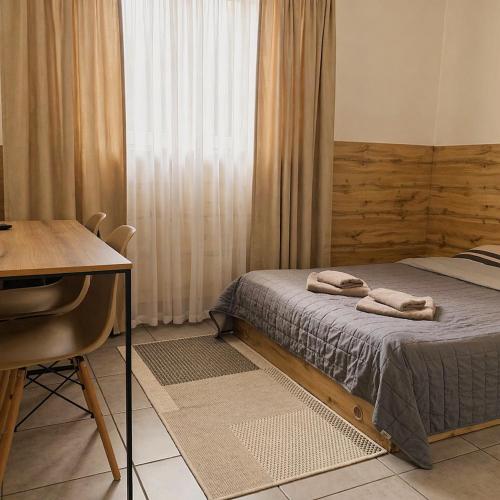 a bedroom with a bed with two towels on it at Mia Hotel in Rivne