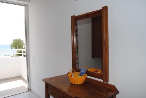 a mirror sitting on top of a table next to a door at Irene Studios in Kefalos