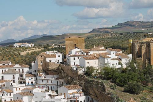 a group of white houses on a mountain at Hotel Tugasa El Almendral in Setenil