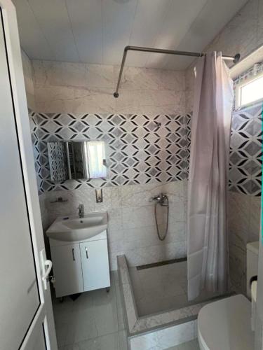 a bathroom with a shower and a sink and a toilet at Paceri in Itʼkhvisi