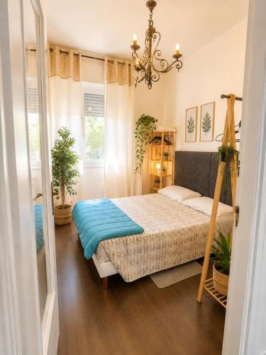 a bedroom with a bed and a chandelier at Vista dall' Eden in Mortola Superiore