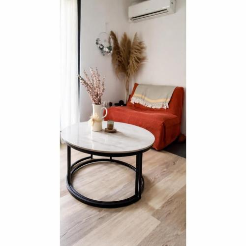 a coffee table in a living room with a couch at le Cosy - Studio Apparthotel in Saint-Denis
