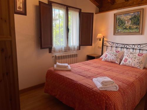 a bedroom with a bed with two towels on it at VILLA ISABEL in Piloña