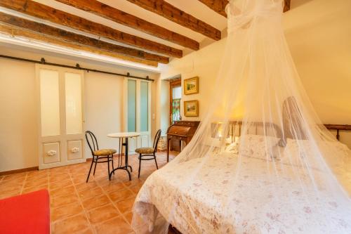 a bedroom with a bed with a veil on it at Petit Ca l'Andorrà in Vila-Sana