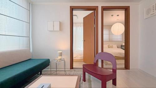a living room with a couch and a chair at SOYO-SOOP Stay in Seoul