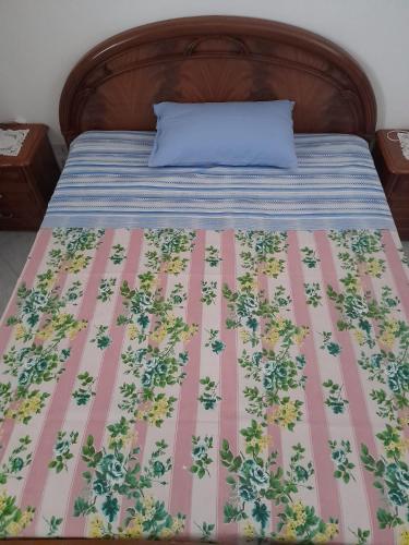 a bed with a blue pillow on top of it at Copertino da Amare in Copertino