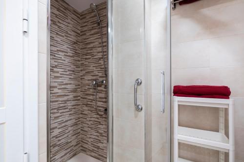 a shower with a glass door in a bathroom at Sol y breeze in Torre del Mar