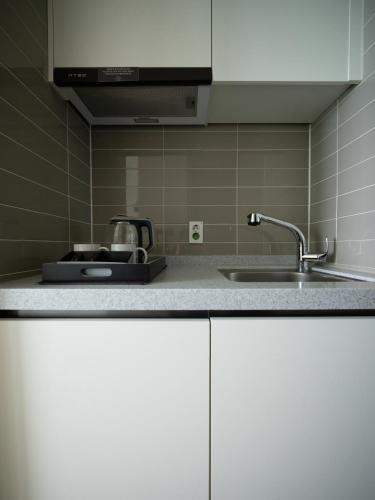 a kitchen with a sink and a counter top at Gangneung Top Ocean in Gangneung